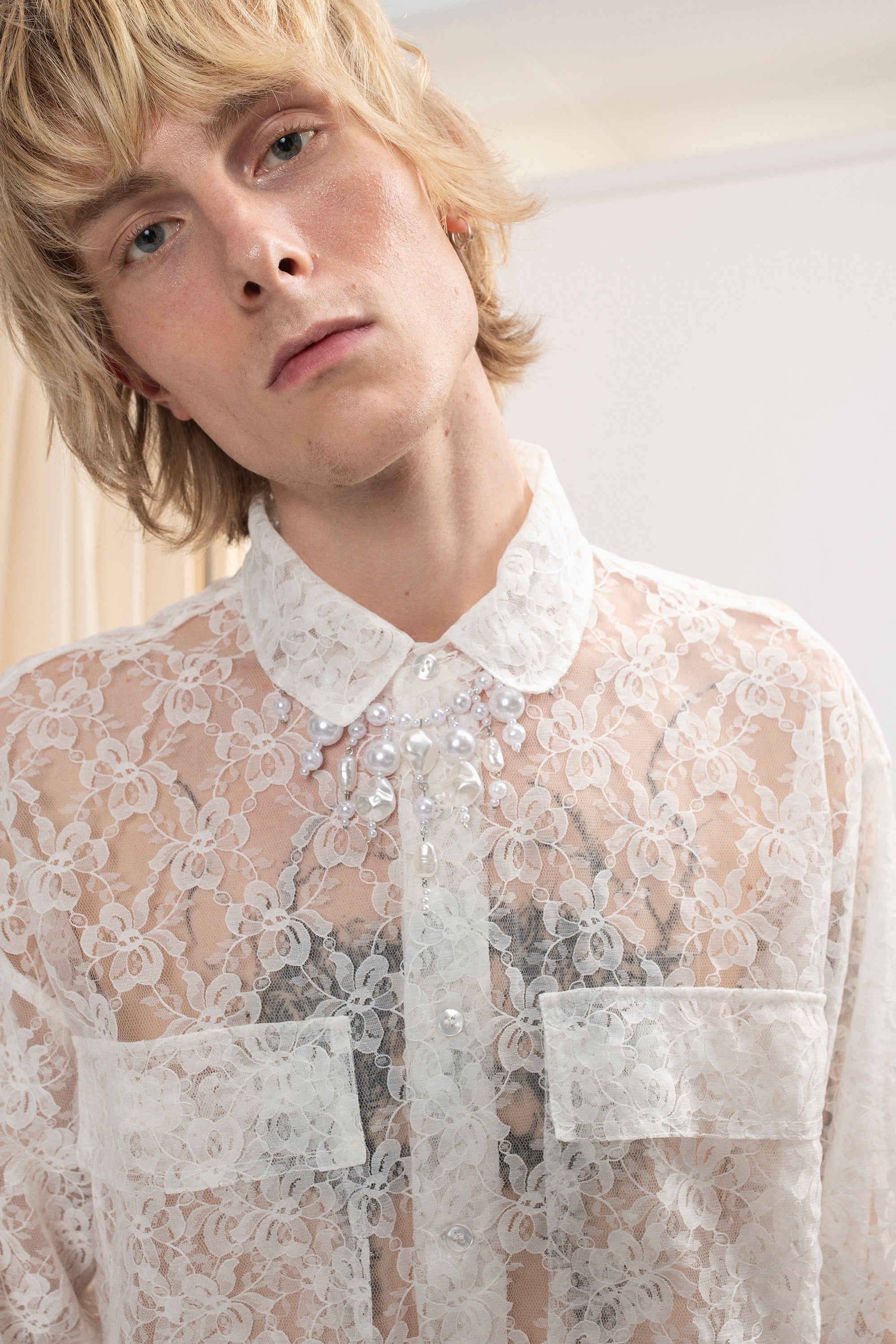 A man wearing Lace Shirt in Ivory by Mirkka Metsola.